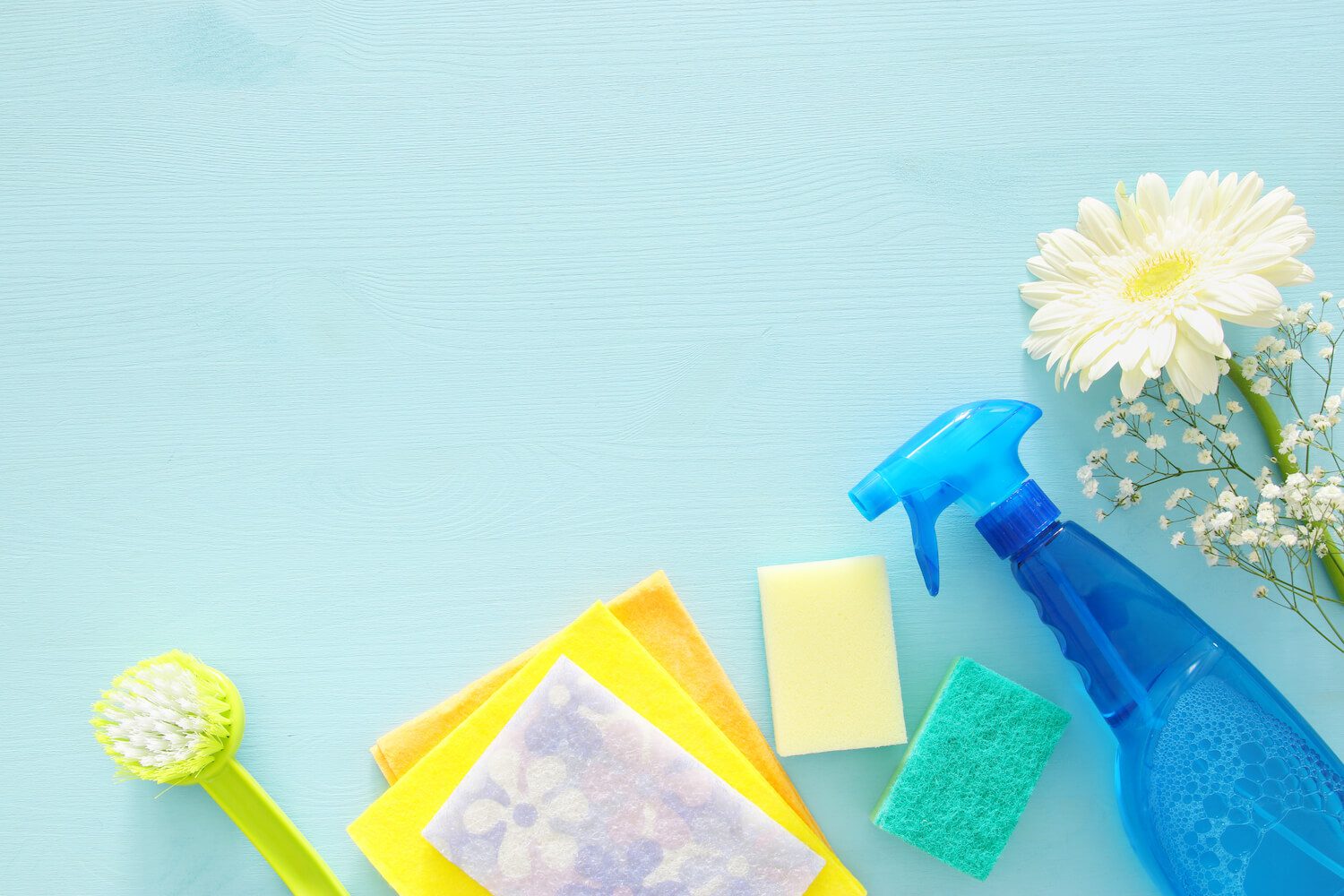 Spring cleaning concept with supplies on wooden table